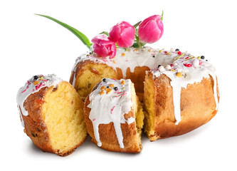 Pieces of tasty Easter cake and flowers on white background