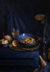 blue and yellow still life with cooked pasta