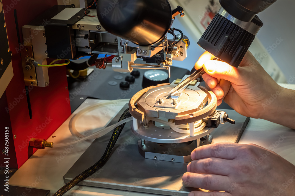 Poster Production of microelectronics. Examining printed circuit board under microscope. Creation microprocessor. Human hands with tweezers. Creation of modern microprocessor. Manual testing of microchips.