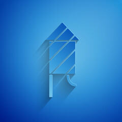 Paper cut Firework rocket icon isolated on blue background. Concept of fun party. Explosive pyrotechnic symbol. Paper art style. Vector