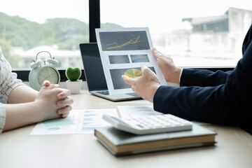 Two business leaders talk about charts, financial graphs showing results are analyzing and calculating planning strategies, business success building processes