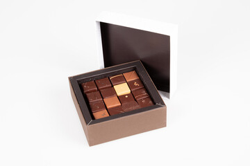 Assortment of variety square fine artisanal chocolate pralines candy in open box