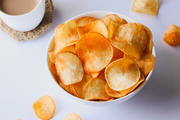 spicy masala tapioca chips Keripik singkong or Cassava chips Indian milk tea chai India Indonesia Brazil Sri Lanka Kerala fried snacks food tea time food fried in coconut oil