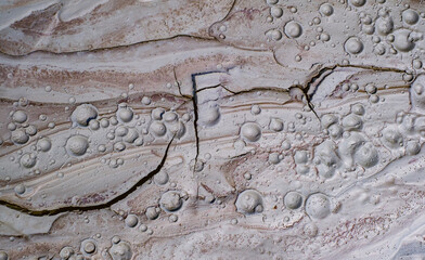 Small craters in mud volcanoes's clay river. Buzau county, Romania.