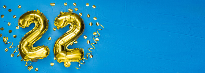 number twenty two gold foil balloon. Birthday or anniversary card with the inscription 22. blue...