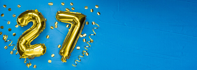 golden foil balloon number twenty seven. Birthday or anniversary card with the inscription 27. blue...