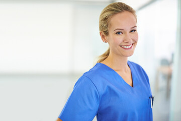 Medicine is her calling. Portrait of a confident young doctor wearing blue scrubs.