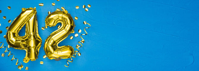 gold foil balloon number forty two. Birthday or anniversary card with the inscription 42. blue...