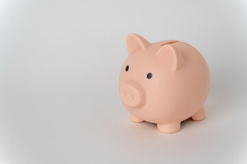 Pink piggy bank on a white background. The concept of money accumulation, financial well-being, banking security, pension savings.