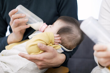 ミルクを飲むアジア人の双子の赤ちゃん	