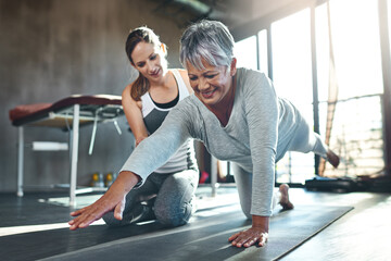 Get fit and have fun while doing it. Shot of a senior woman working out with her physiotherapist.