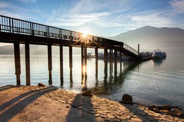 Fototapeta premium Asia culture - Beautiful landscape of lake level reflect fantasy dramatic sunrise sky in Sun Moon Lake , in Taiwan, Asia. the famous travel attractions in Nantou ,Taiwan. Scenery of Sun Moon Lake, 
