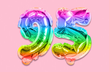 Rainbow foil balloon number, digit ninety five on a pink background. Birthday greeting card with...