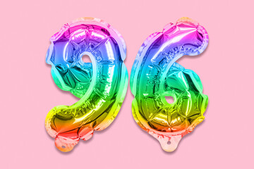 Rainbow foil balloon number, digit ninety six on a pink background. Birthday greeting card with inscription 96. Top view. Numerical digit. Celebration event, template.