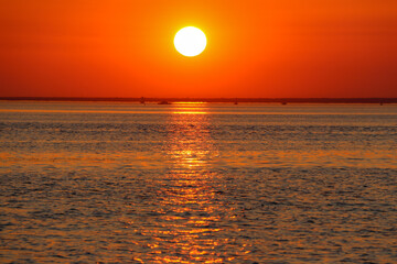 red sunset over the bay with silhouettes