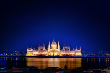 Fototapeta na wymiar A magical view of the ancient city. A beautiful old building on the danube river. Hungarian parliament building at night, budapest, hungary. Beautiful architecture illuminated by lanterns