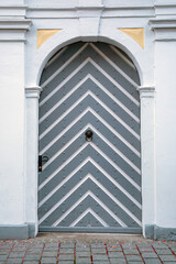 Striped door. Entrance to the house. European building. Architecture.