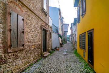 Fototapeta na wymiar Ancient narrow street in europe. A path made of stone. Ancient houses. Antique architecture.