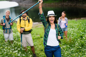 Group of happy hiker friends trekking as part of healthy lifestyle outdoors activity