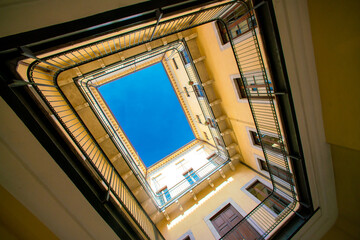 Symmetrical photography. Old building bottom up view. A photo surrounded by an architectural structure from all sides. Beautiful perspective of the building