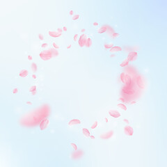 Sakura petals falling down. Romantic pink flowers vignette. Flying petals on blue sky square background. Love, romance concept. Elegant wedding invitation.