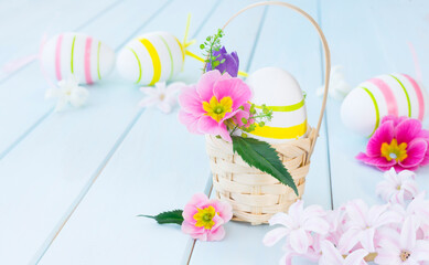 Easter egg in a basket decorated with flowers