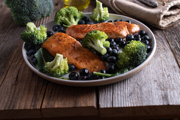Superfoods such as salmon, broccoli and blueberries on a plate