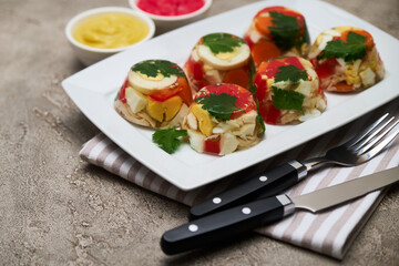 Portion of delicious chicken aspic on a plate isolated on concrete table