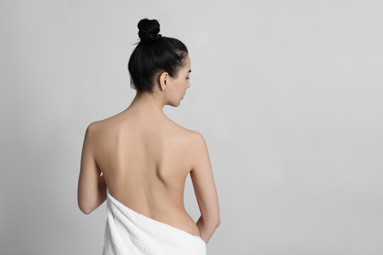 Back View Of Woman With Perfect Smooth Skin On Light Background, Space For Text