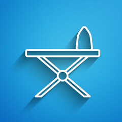 White line Electric iron and ironing board icon isolated on blue background. Steam iron. Long shadow. Vector