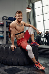 Fototapeta premium Portrait of sportsman checking heart rate on fitness trekker after training in gym