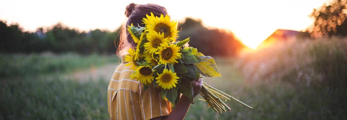 Fotobehang Girl and sunflowers © Sergii Mostovyi