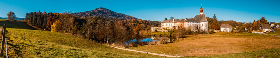 Fototapeta na wymiar High resolution stitched panorama with a monastery at the famous Hoeglwoerther See lake, Hoeglwoerth, Bavaria, Germany