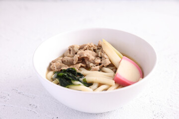 Udon noodles with pork isolated in white background