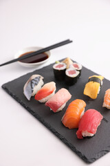 Sushi Set nigiri and sushi rolls with soy sauce and chopsticks Japanese food isolated in white background