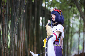 Japanese young woman hunter cosplay with bow on Japanese garden - obrazy, fototapety, plakaty
