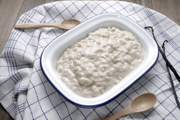 homemade vanilla rice pudding in a white enamel bowl