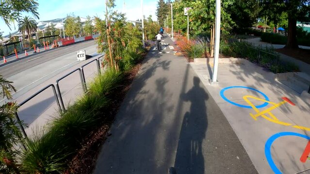 Family bike riding at the Google Campus in Mountain View, California (USA). 4K GoPro, action footage, POV.