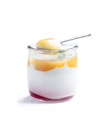 White creamy yogurt with yellow fruitty puree in small jar isolated on white