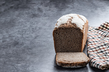 Homemade wholemeal bread on gray stone background