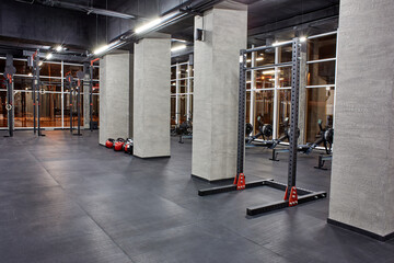 Various exercise machines for physical training and section for crossfit in spacious, empty gym...