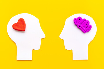 Brain and heart. Logic and emotion communication concept with two paper heads