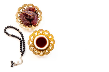 Islamic rosary with dates and tea. Ramadan Kareem concept.