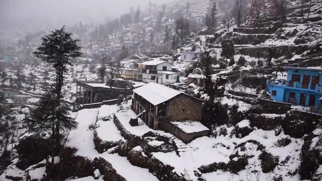 Village homes covered in snow during winters in India