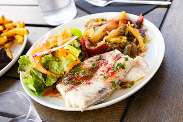 French-style molva or sea pike with vegetables. French cuisine