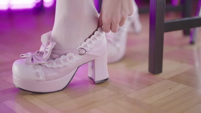 Female feet in white sock put on lolita high heels close-up 4K