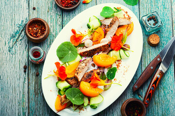 Sliced roasted steak with vegetables, salad