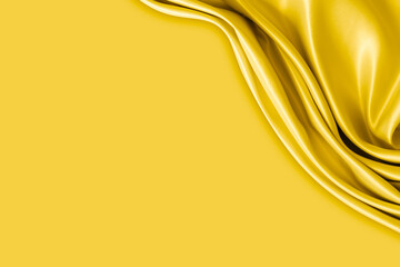 Beautiful elegant wavy yellow satin silk luxury cloth fabric with monochrome background design. Copy space