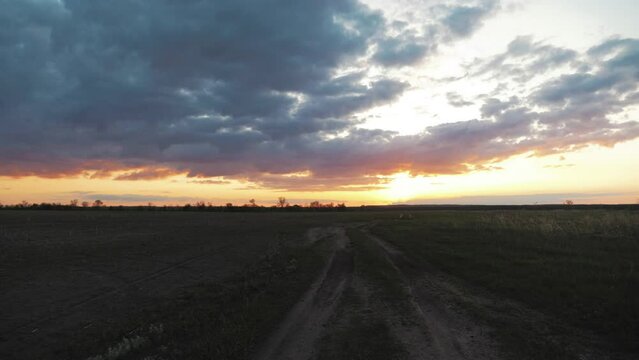 Green fild with beautiful sky. Green field in the summertime, the sky above it with clouds.