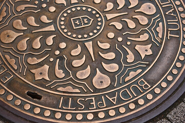 Urban manhole cover in Budapest town main street. Hungary